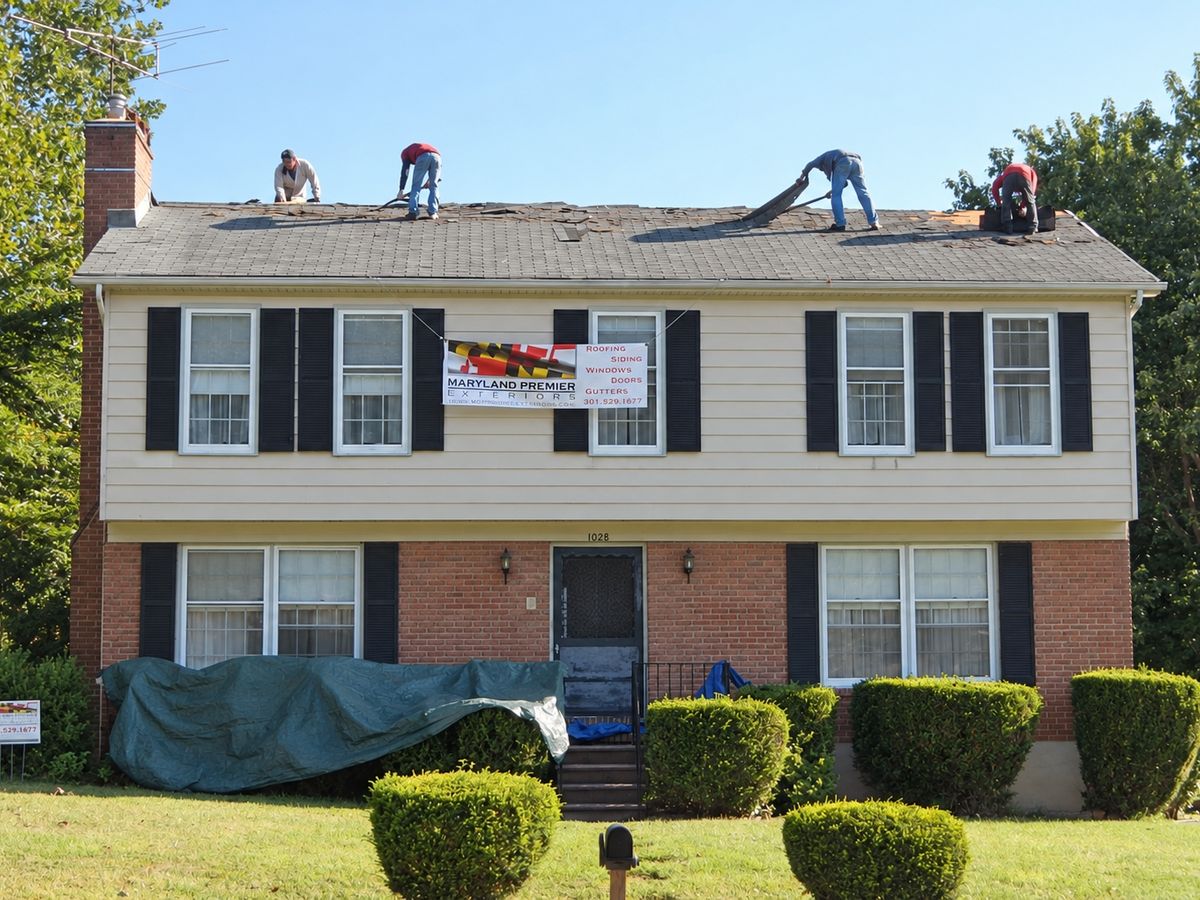 Two-story house with a cream siding upper floor and a brick lower floor